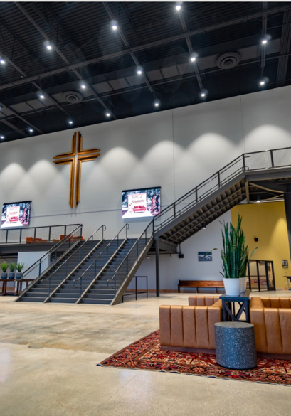 Jacksonville, Florida worship center atrium with a cross, stairs, and seating